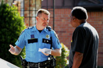 Senior Police Officer M.D. Prause offers burglary prevention advice to a Park Glen resident