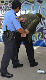 Police Officer Arresting A Graffiti Vandal