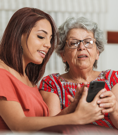 image of a woman and her mother looking at phone