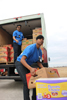 HPD Officer E.J. Joseph and Officer M. Siddiqi load a truck for shipping