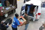 HPD Officer E.J. Joseph and Officer Ted Wang unload supplies